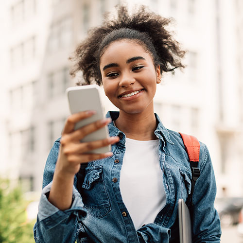 Woman looking at her phone smiling