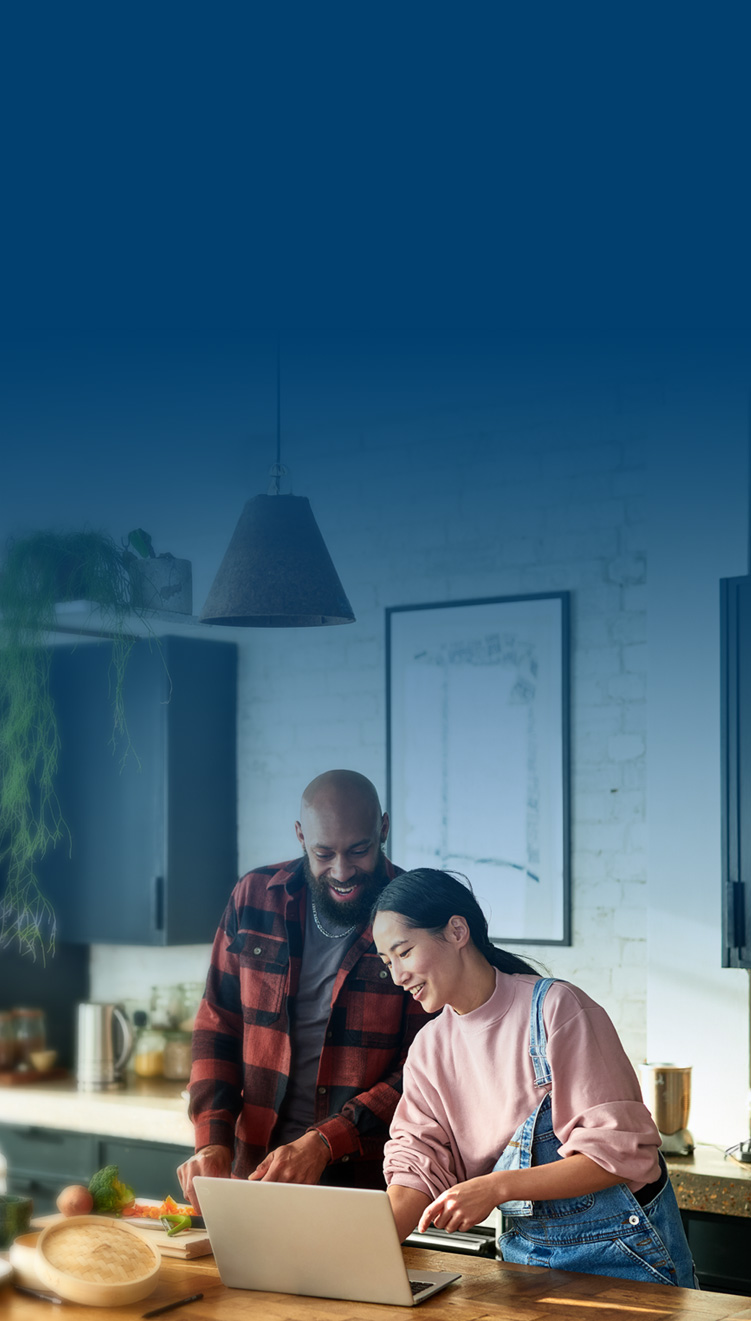 Couple in kitchen cooking