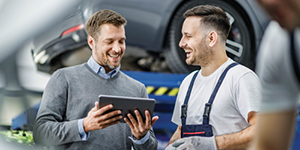 Business owner using an iPad with a customer.